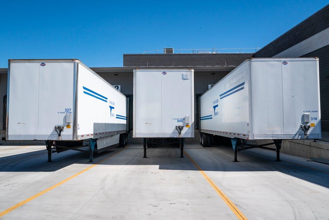 Free Three White Enclosed Trailers Stock Photo